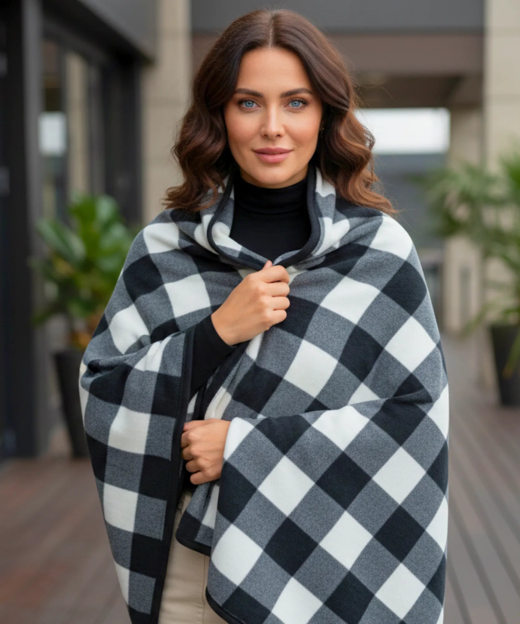 Women's plaid blanket poncho in black and white buffalo check, front view