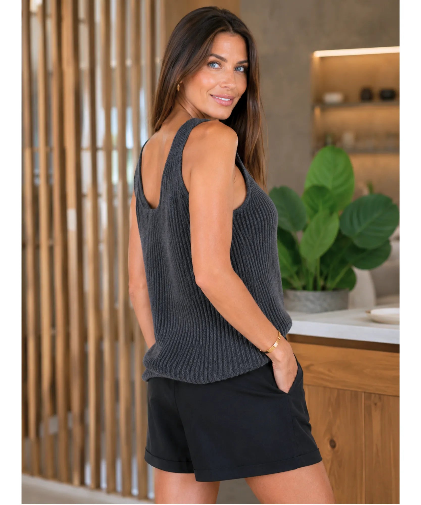 Women's ribbed tank top in charcoal, back view with black shorts