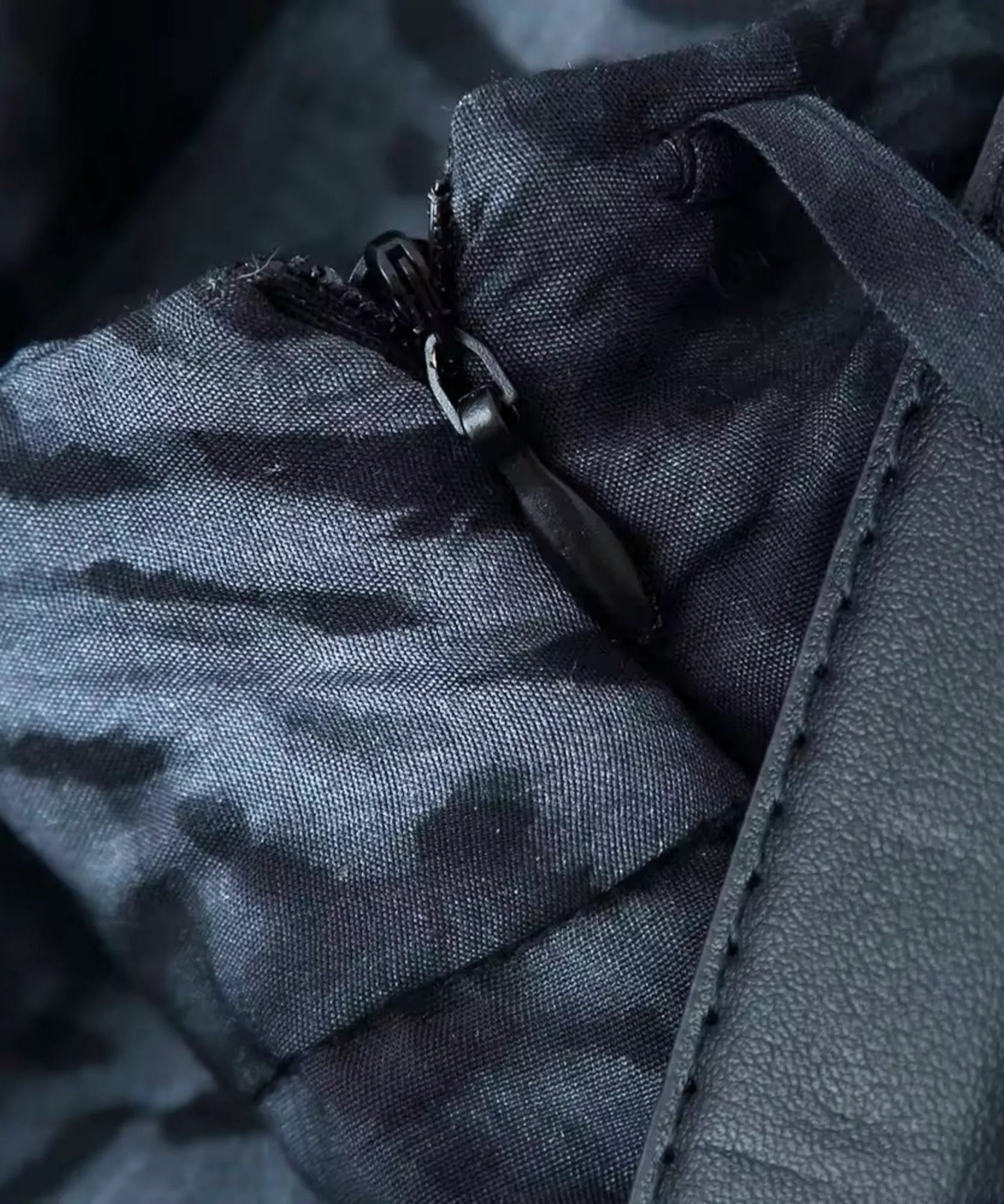 Detail of the invisible side zip on a black marble print skirt