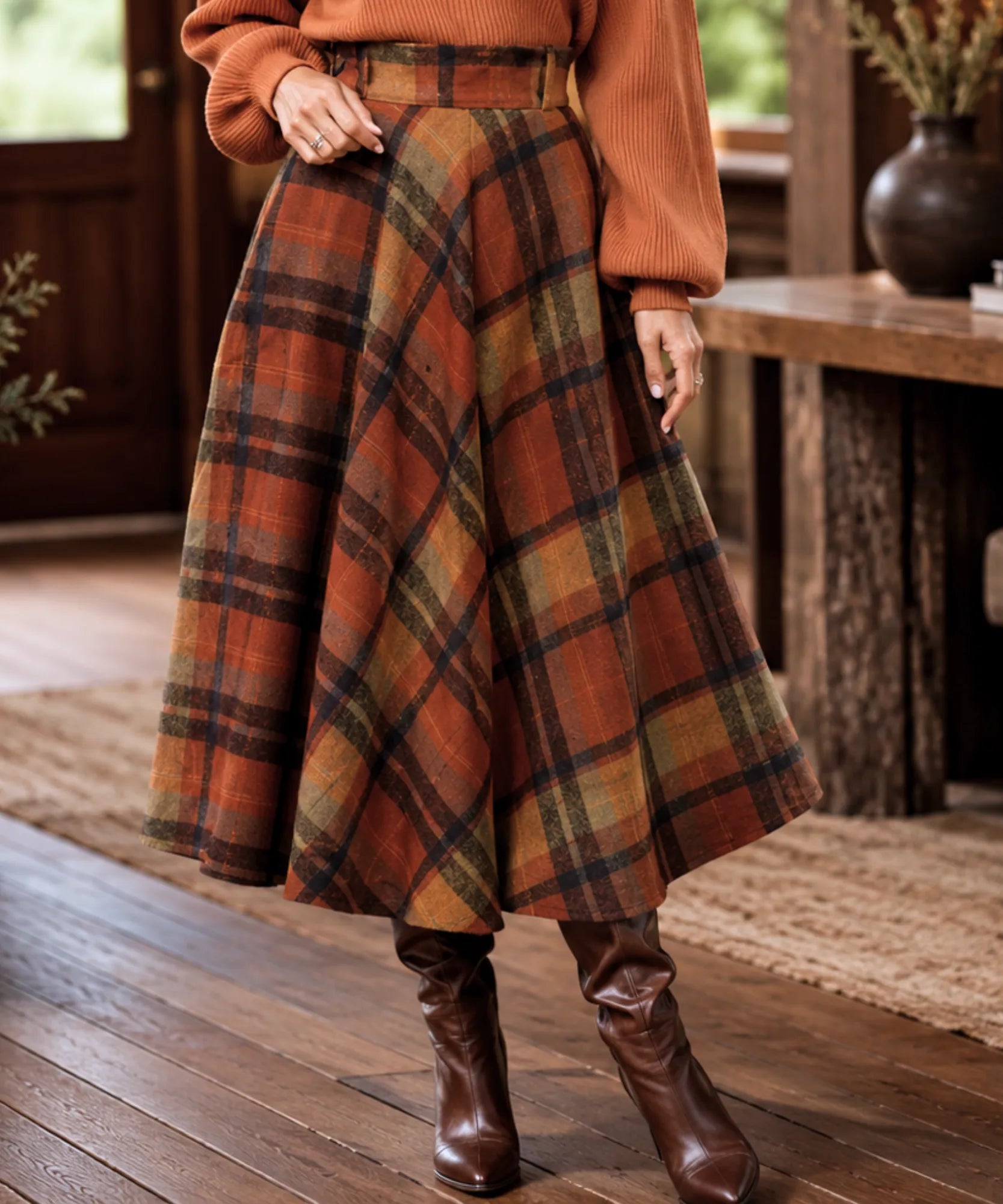 Women's terracotta wool plaid midi skirt styled with turtleneck and boots