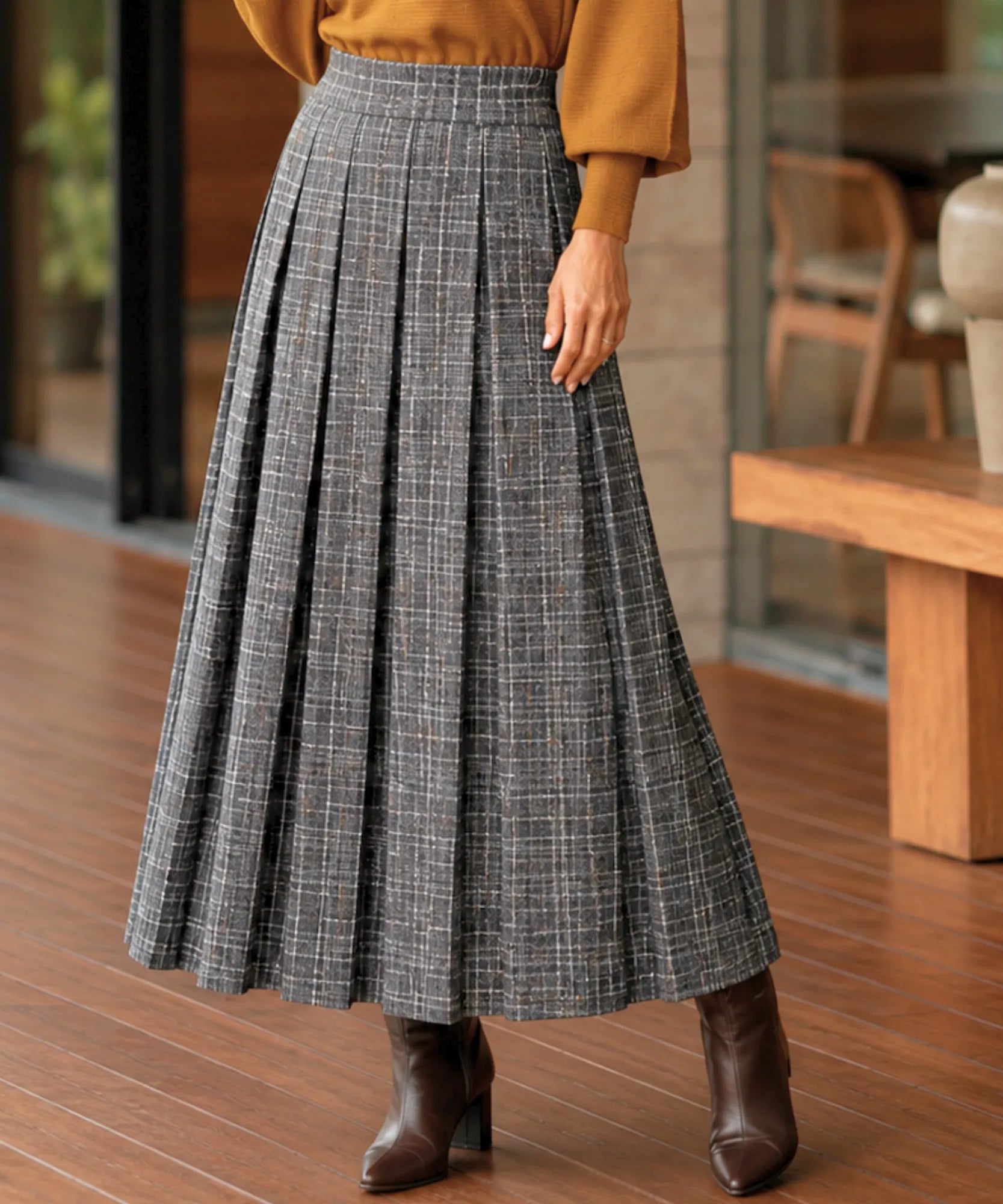 Women's grey plaid pleated wool midi skirt, styled with sweater