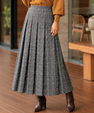 Women's grey plaid pleated wool midi skirt, styled with sweater