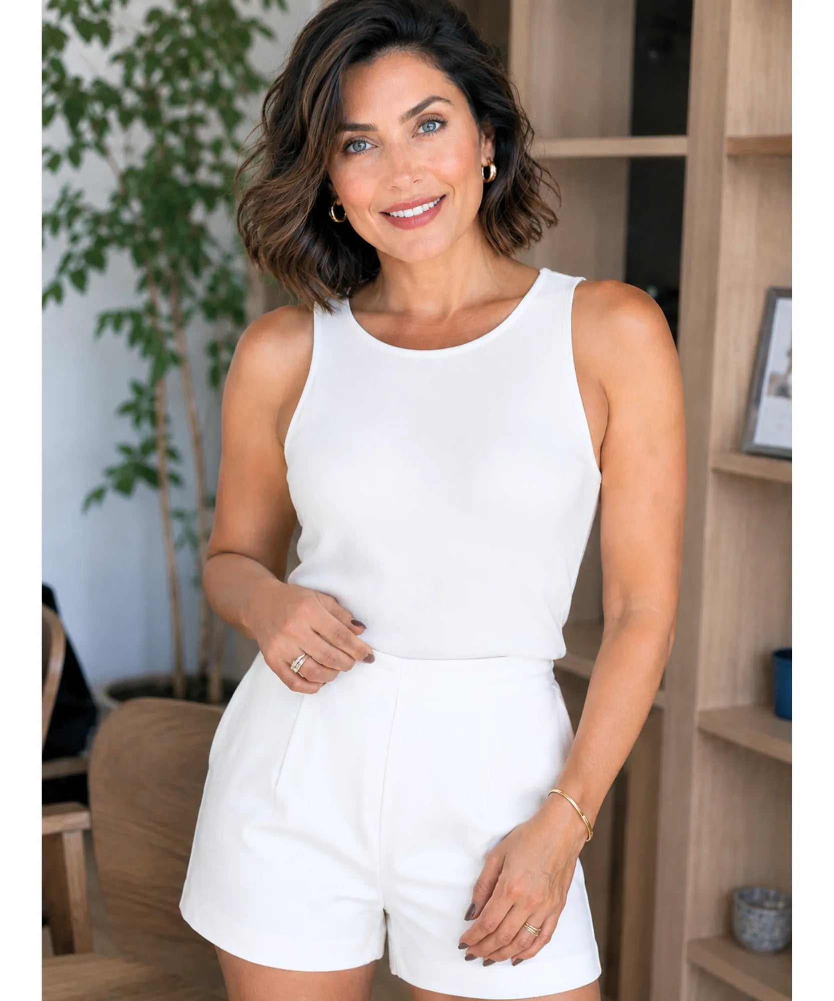 Women's white pleated shorts front view with side pocket