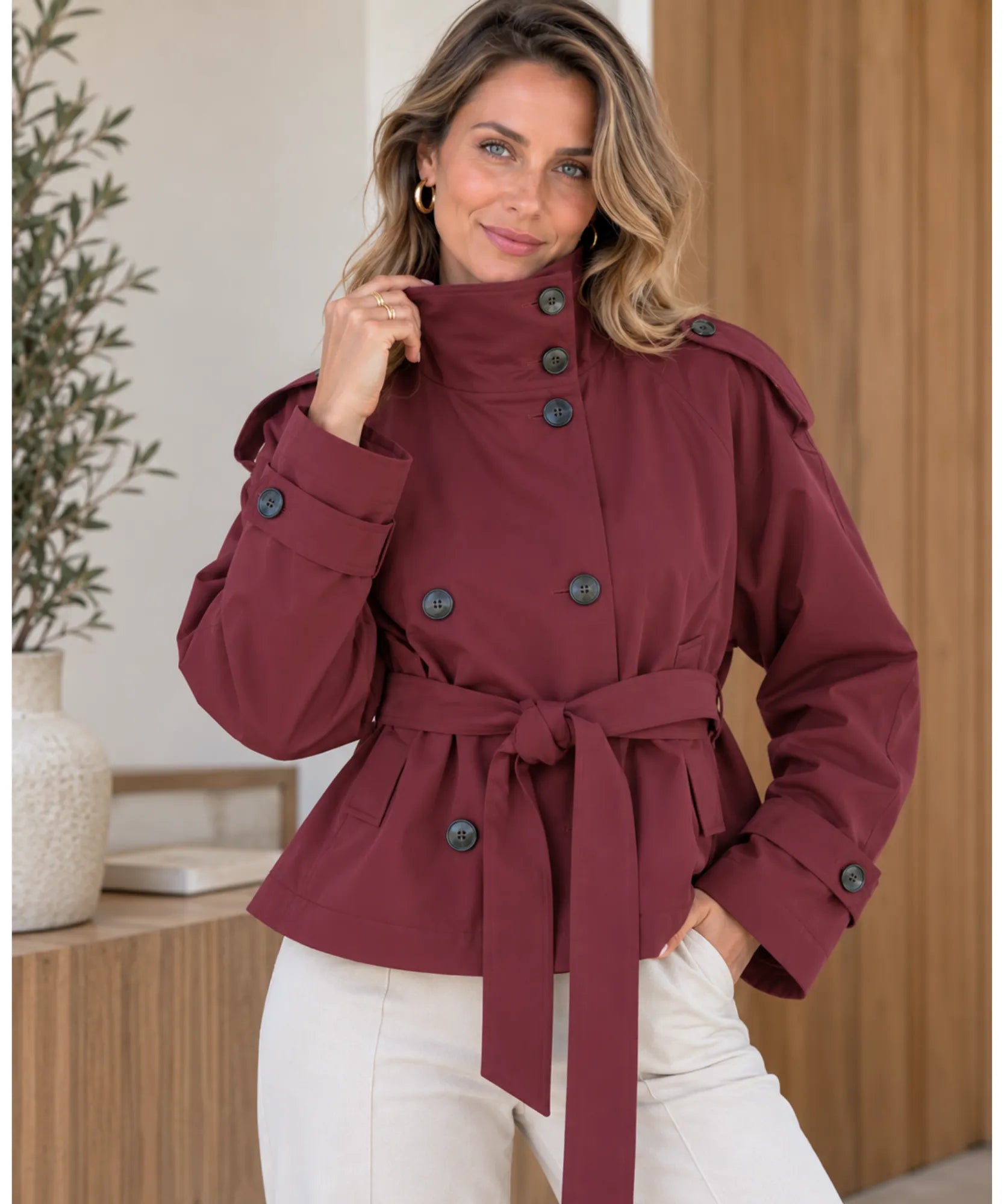 Women's short trench coat in burgundy with buttoned funnel neck, front view