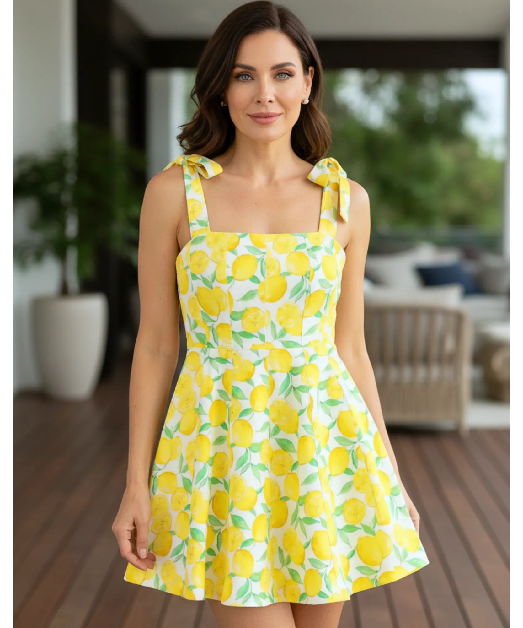 Women's boho mini dress in yellow fruit print, back view with tie detail