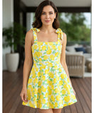 Women's boho mini dress in yellow fruit print, back view with tie detail