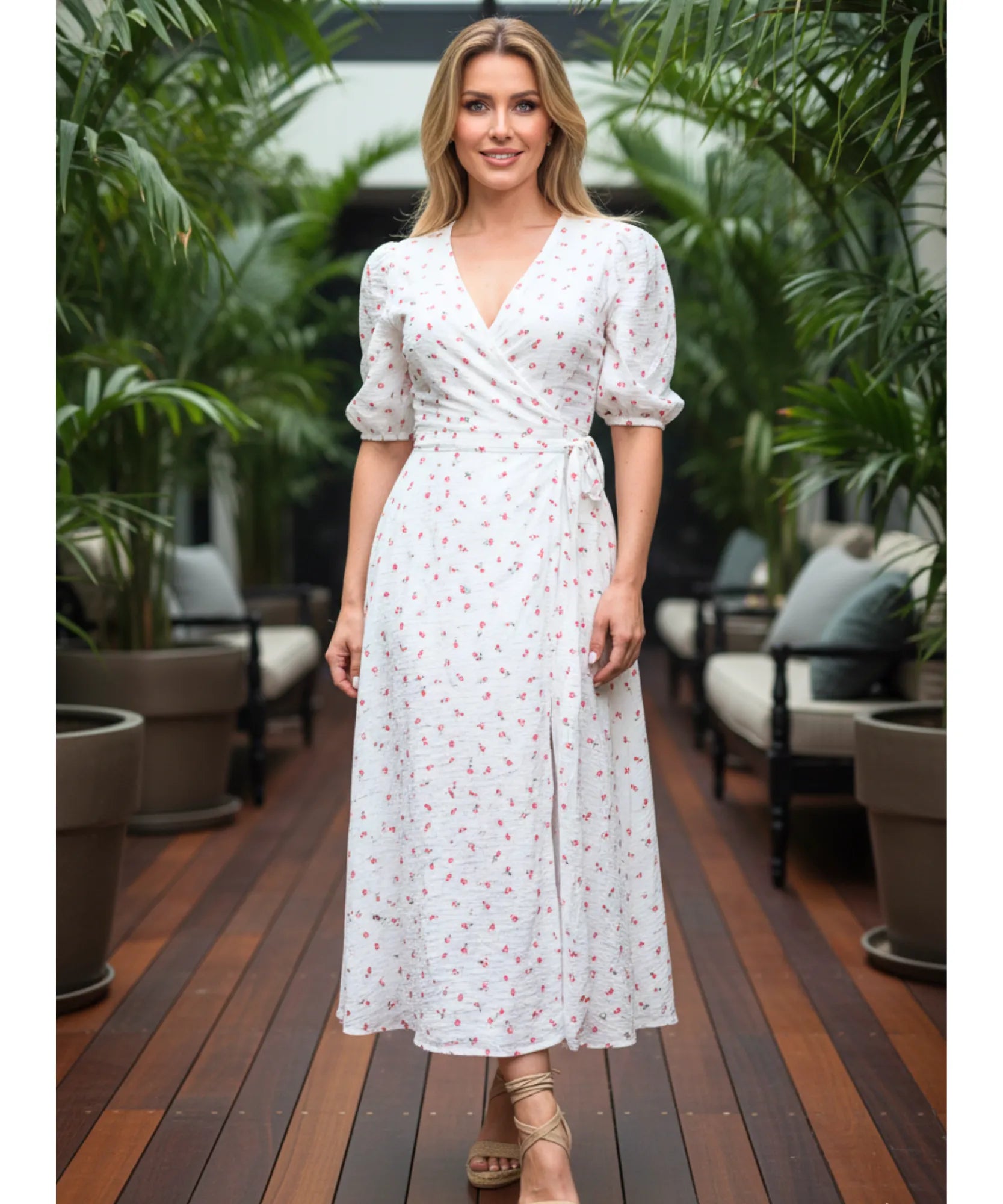 Women's floral wrap midi dress in pink floral print, lifestyle outdoor view