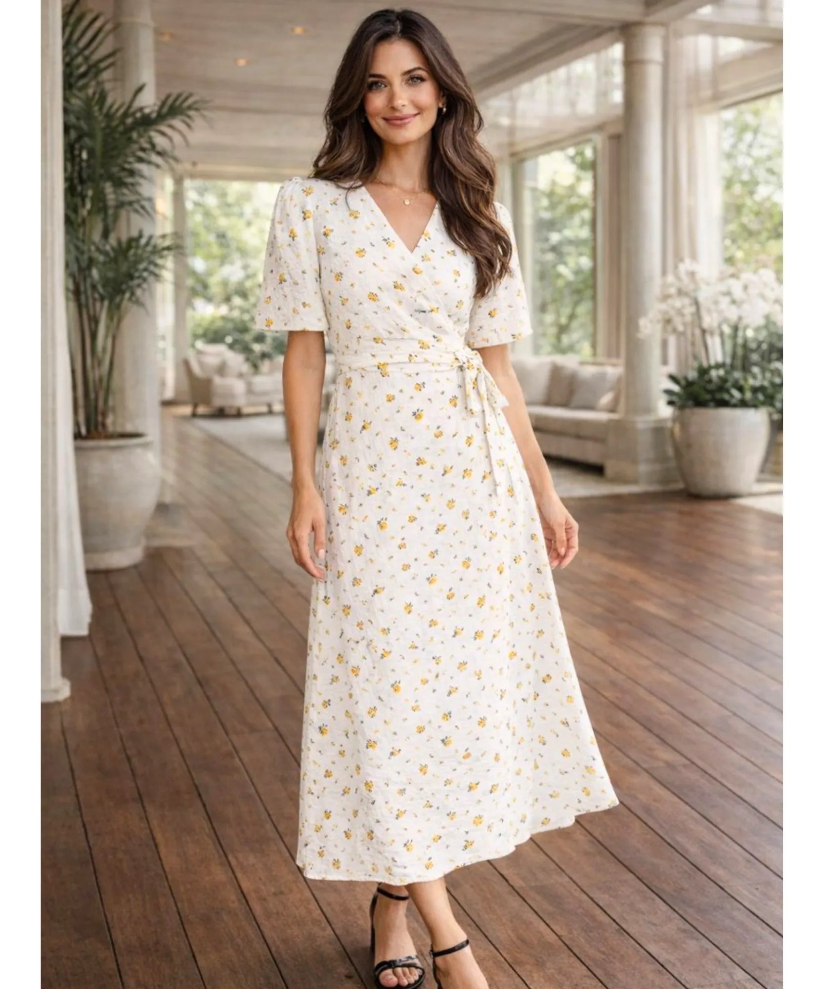 Women's floral wrap midi dress in yellow floral print, lifestyle full length view