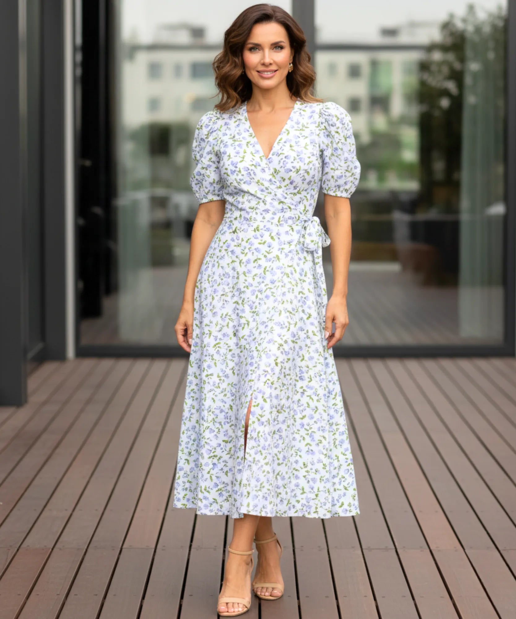 Women's floral wrap midi dress in blue floral print, front view with side slit