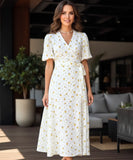 Women's floral wrap midi dress in yellow floral print, front view